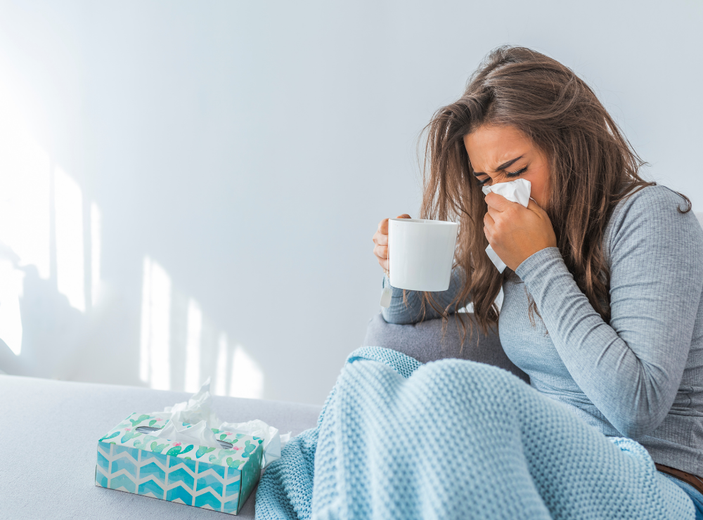 Woman sneezing with tissue